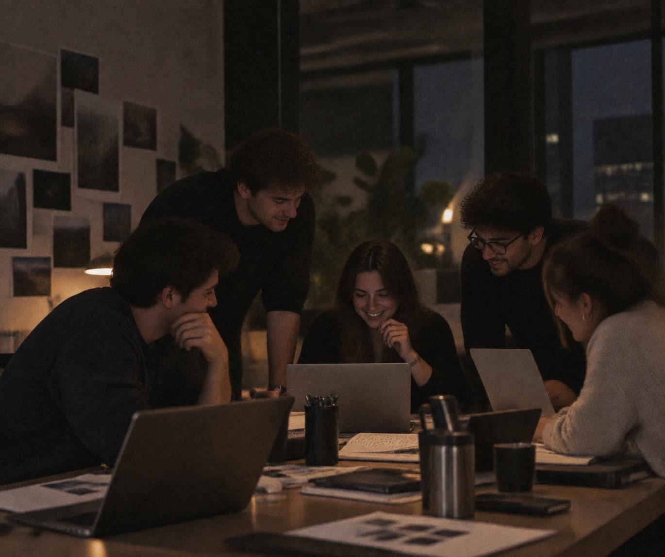 A group gathered around laptops, working together